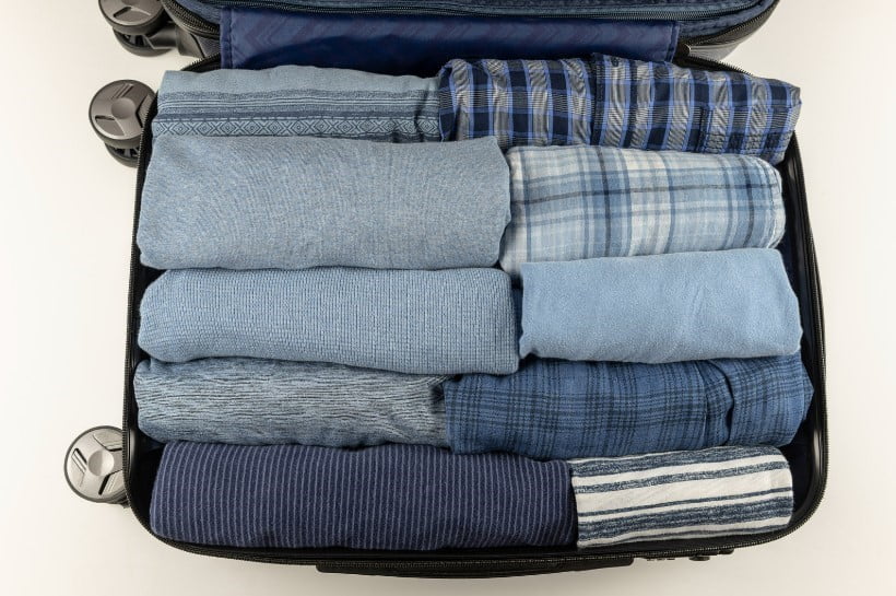rolled clothes in suitcase
