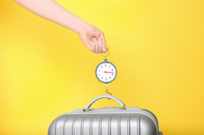 weighing luggage with portable scales